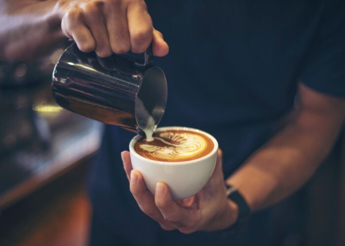 close-up-hands-barista-make-latte-coffee-art-paint